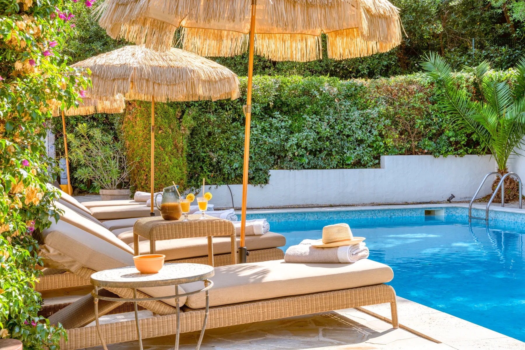 Sun loungers and parasols beside the larger private pool