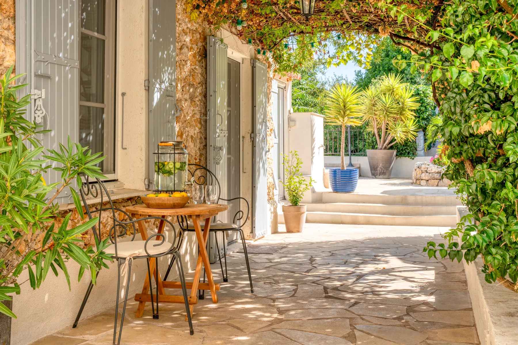 A shaded stone passage opening onto the garden
