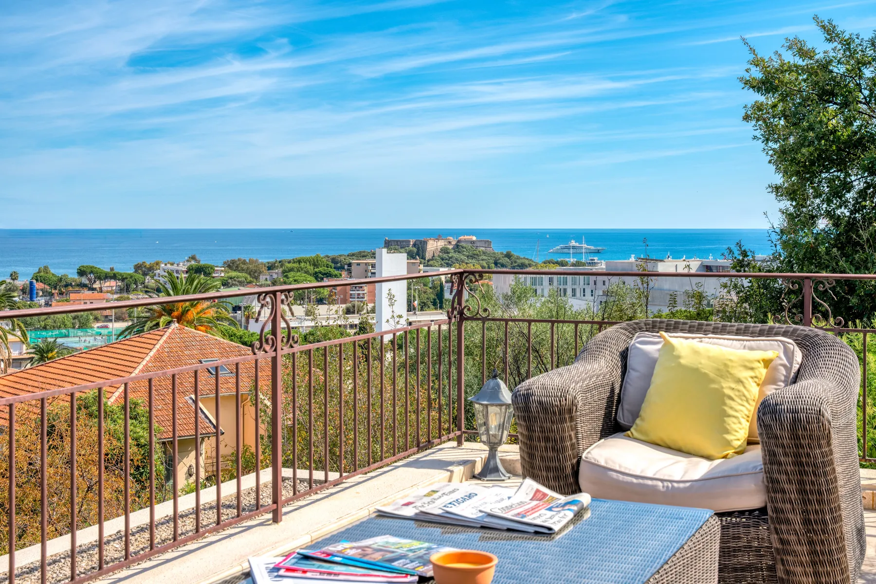 Terrace seating with a wide view across Antibes to the sea