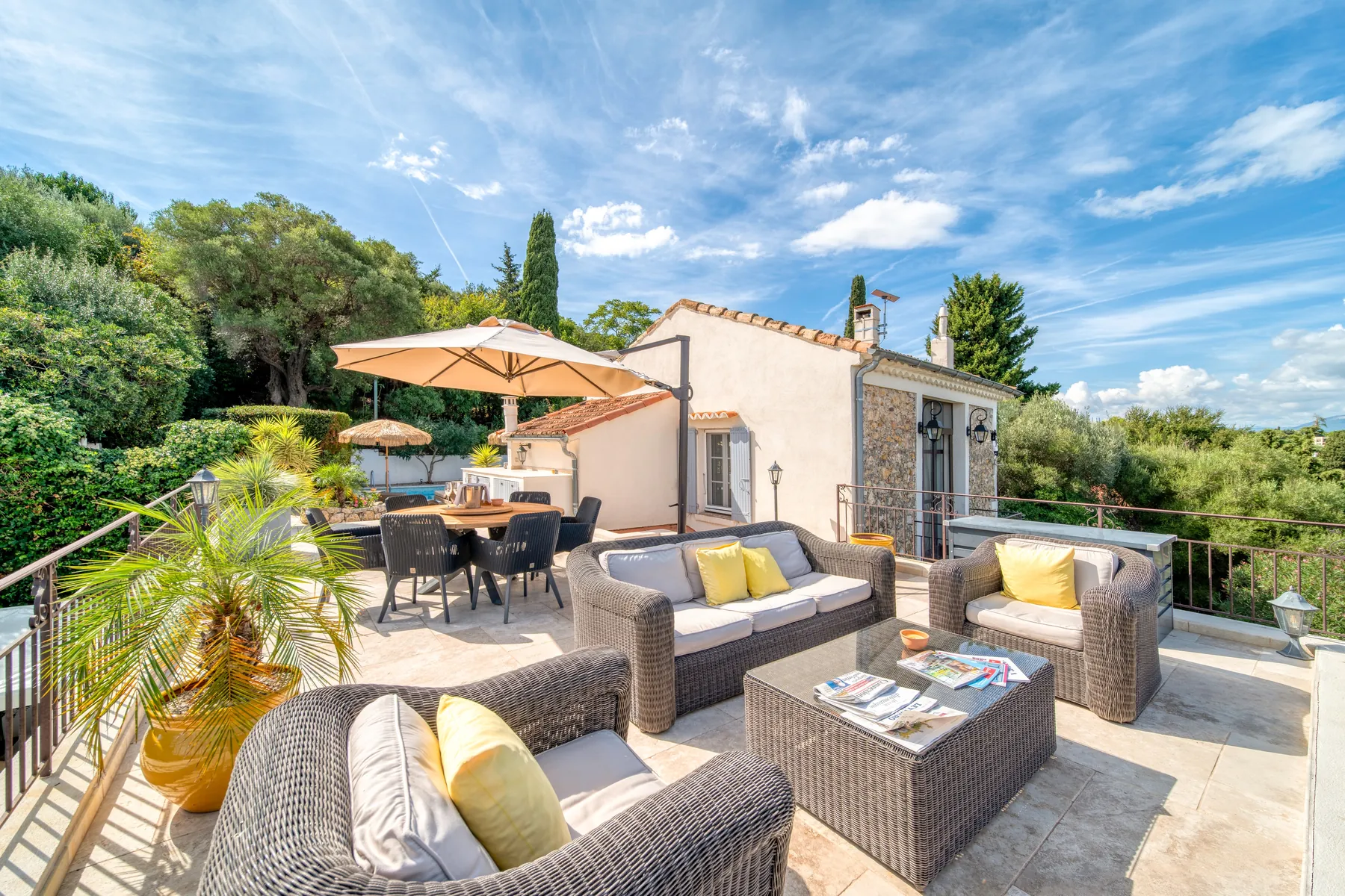 Outdoor lounge framed by palms and garden planting