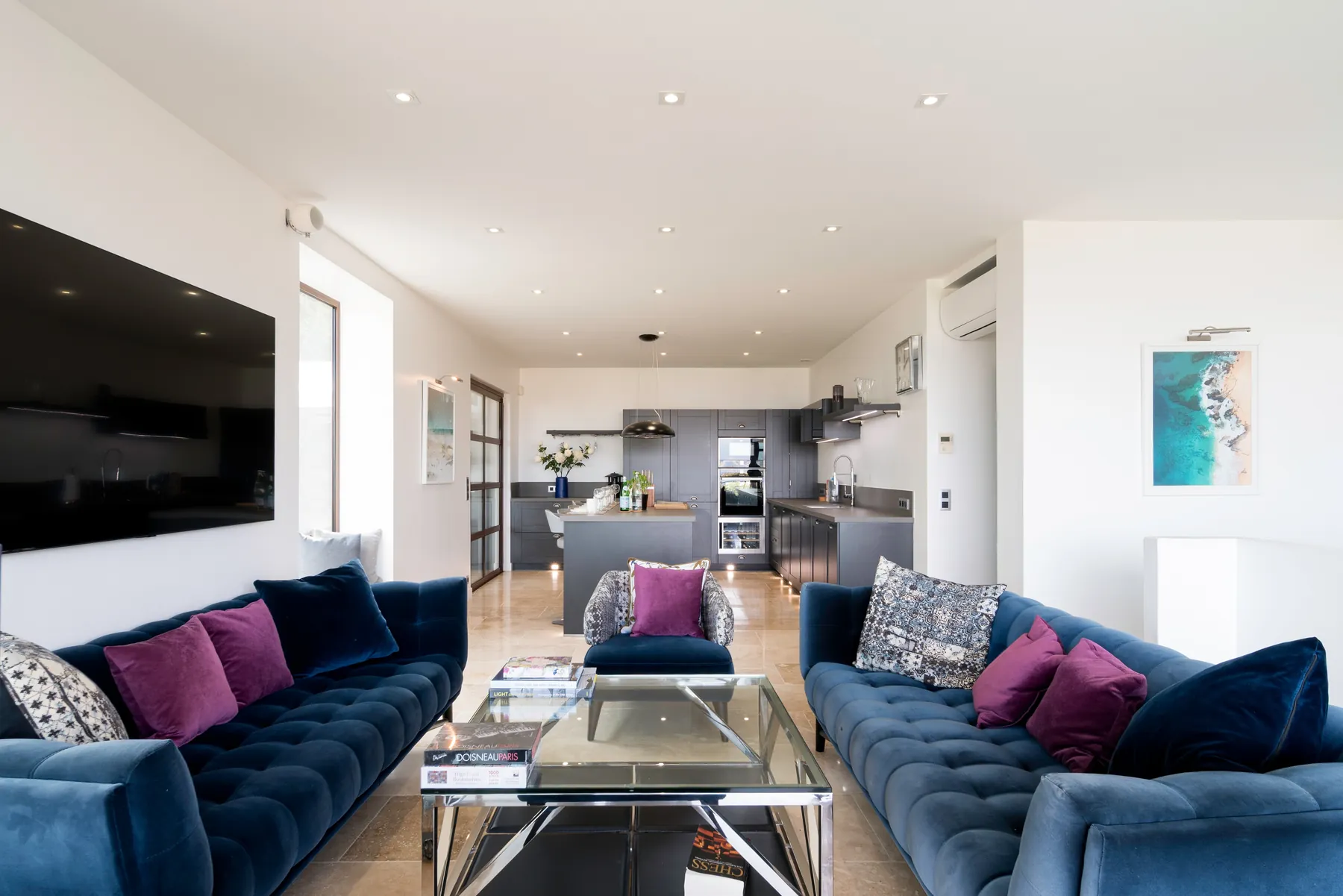 Contemporary lounge with deep blue seating and garden light