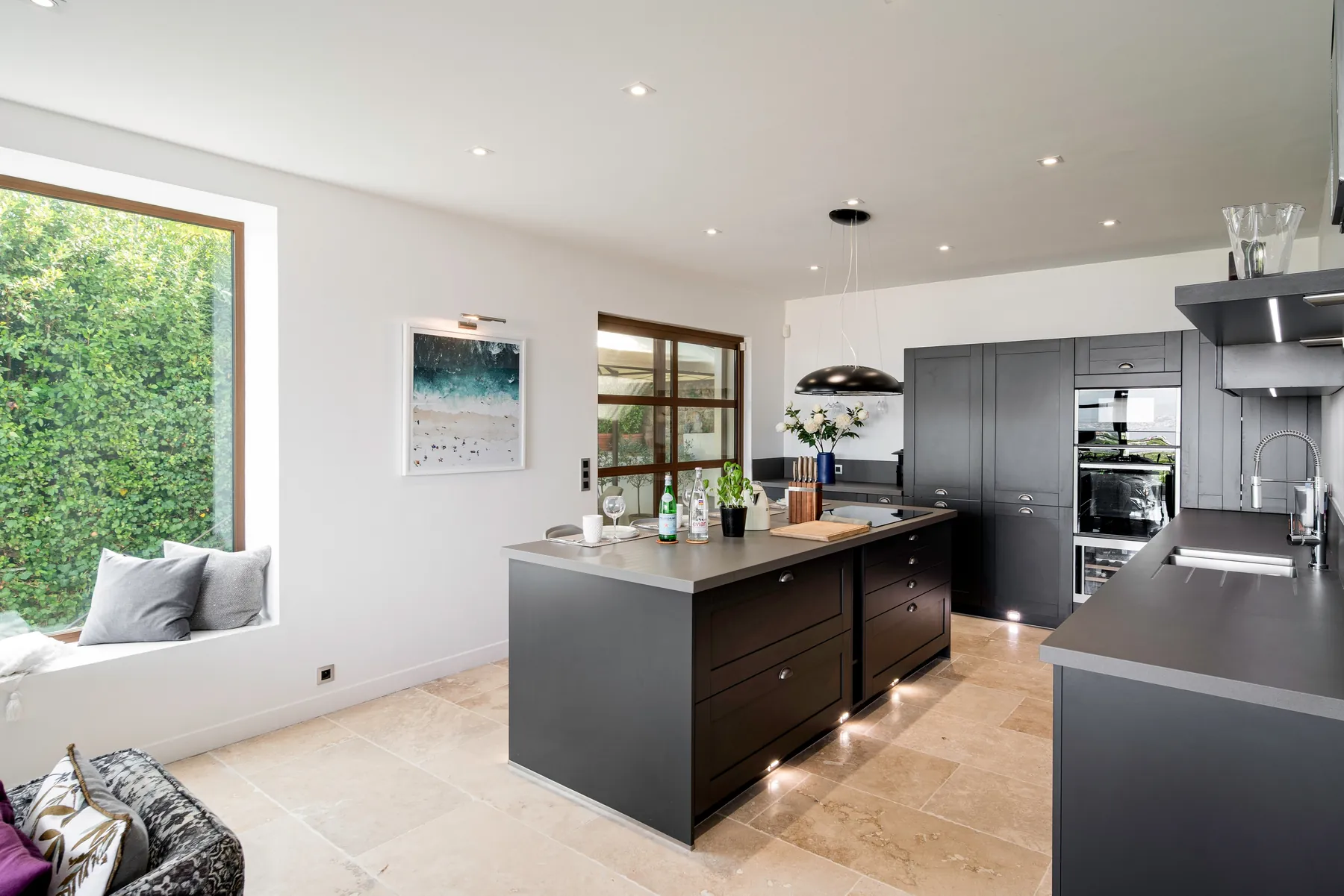 Black contemporary kitchen with a central island