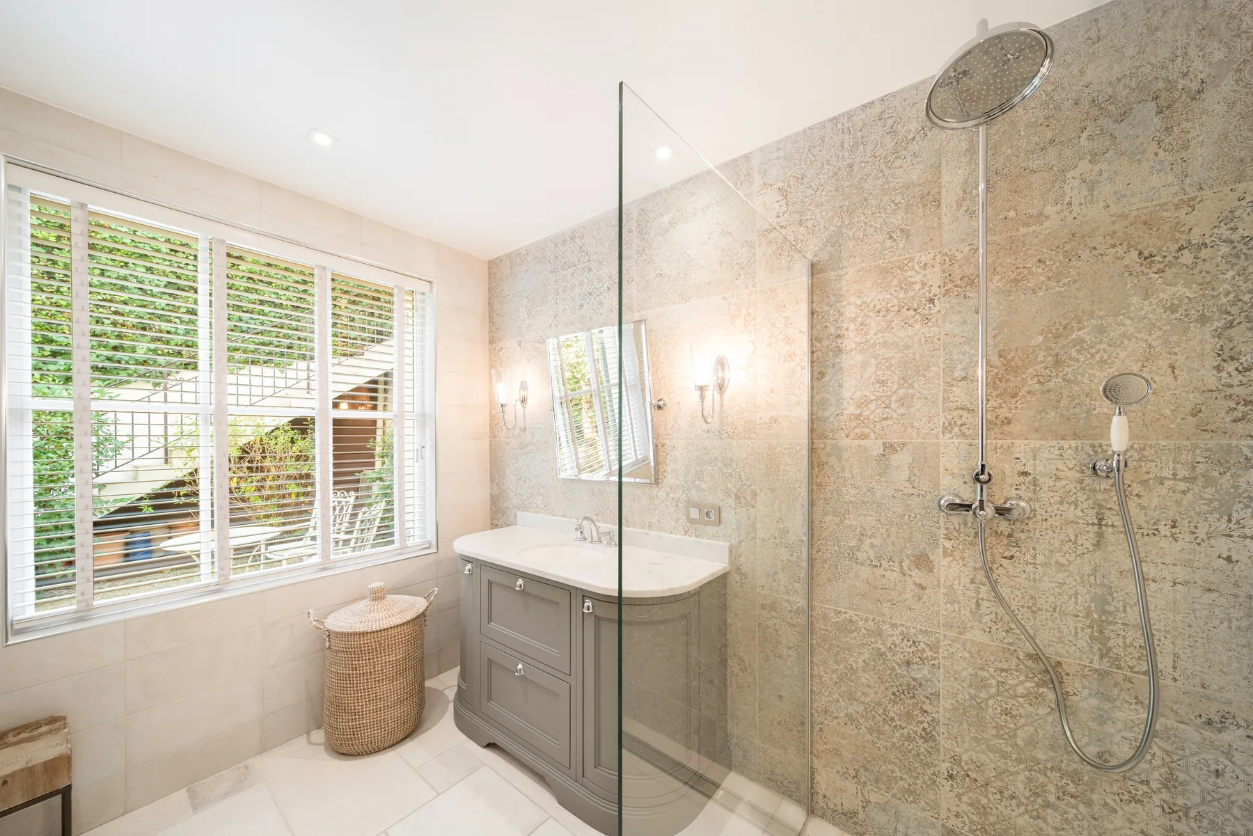 Stone tiled en suite shower room filled with natural light