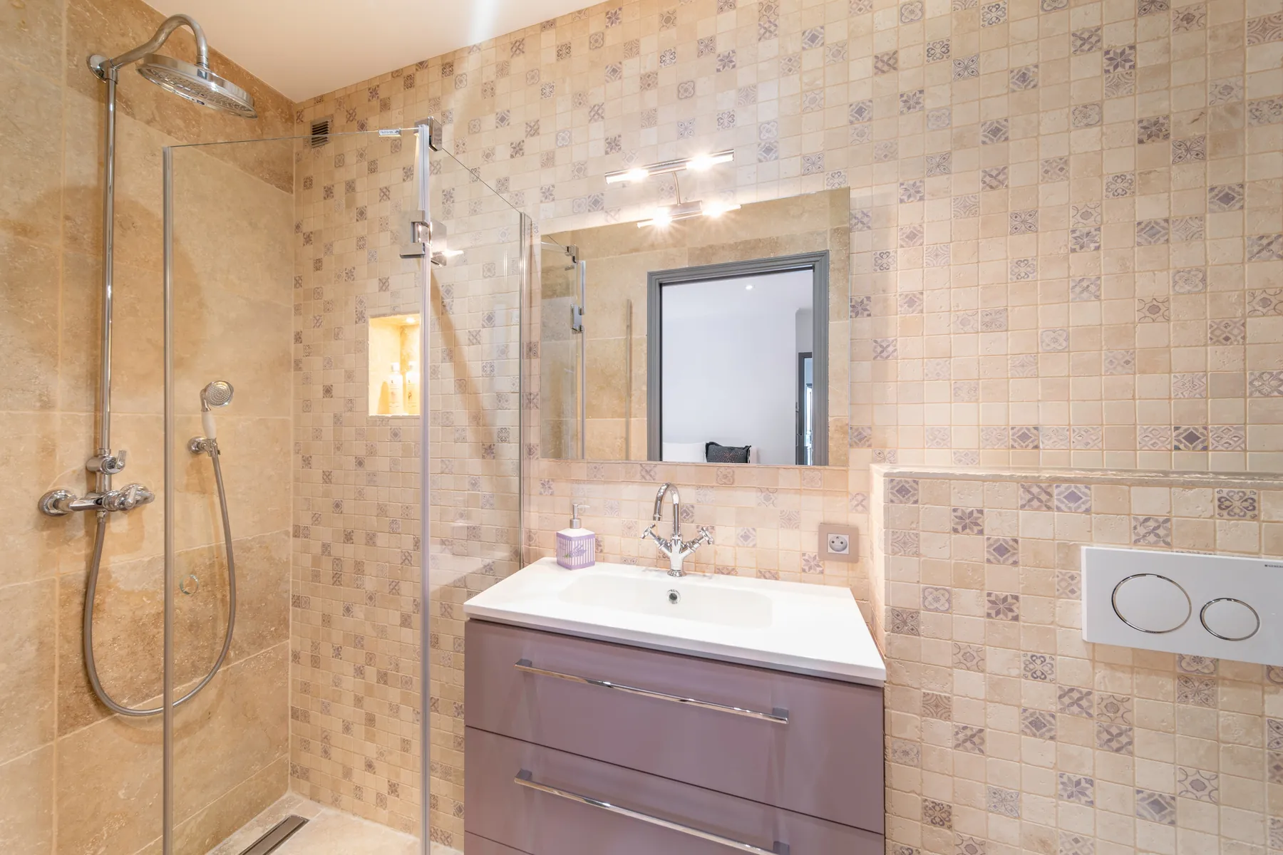 Warm stone tiled bathroom with shower and vanity
