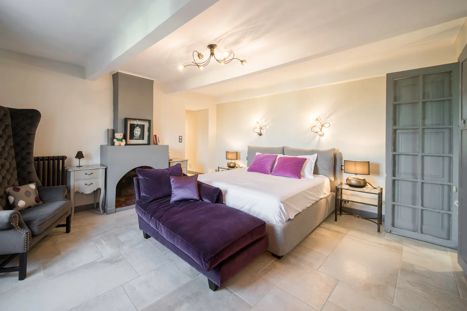 Spacious Bedroom 1 with upholstered bed and lounge seating