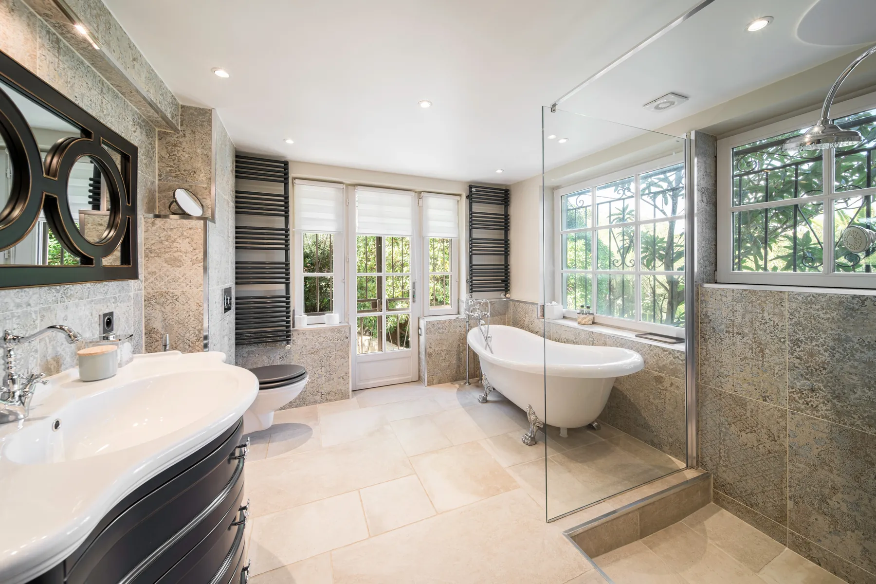 Light filled private bathroom with a freestanding bath