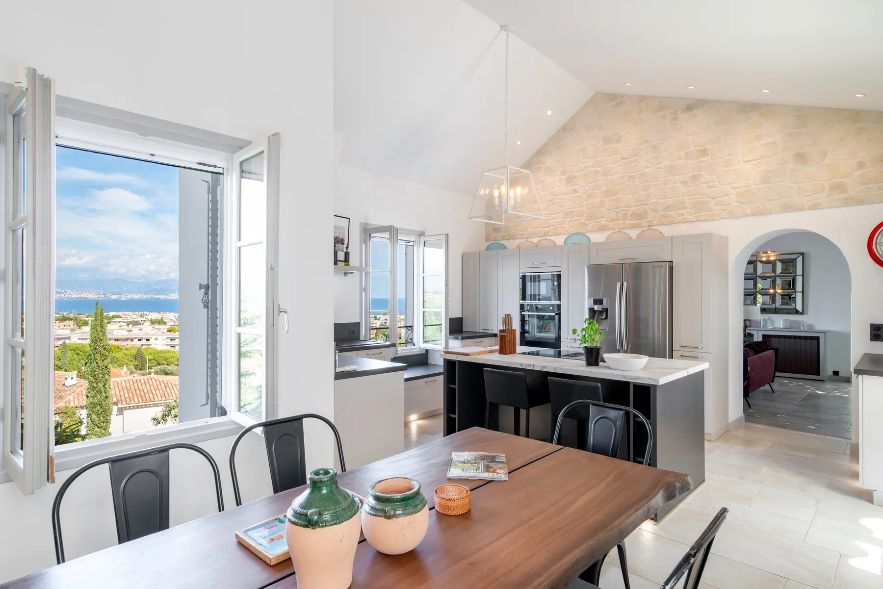 Second kitchen and dining space beneath a high ceiling