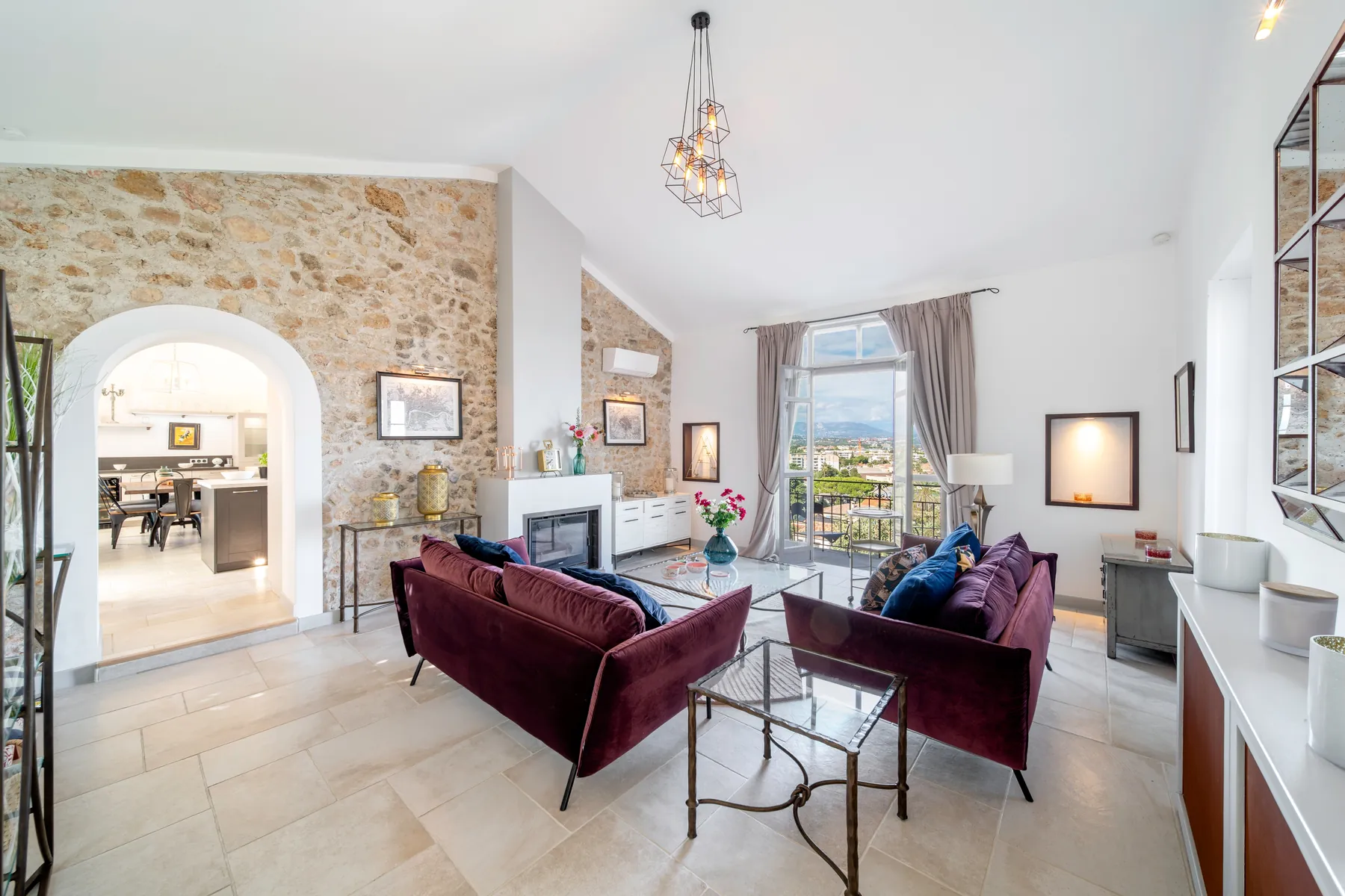 Stone walled Provençal living room with colourful seating