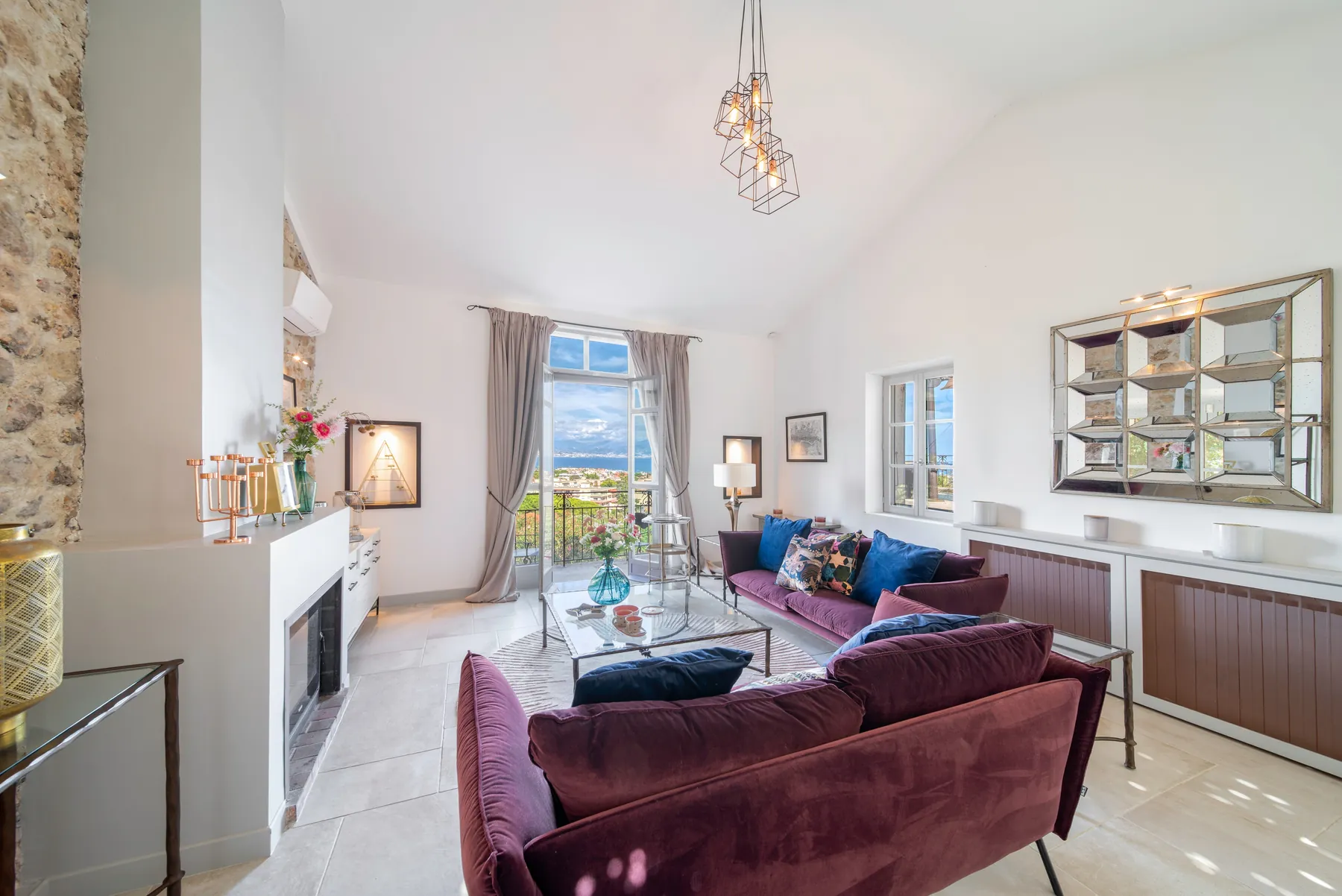 Traditional lounge with stone walls and tall French doors