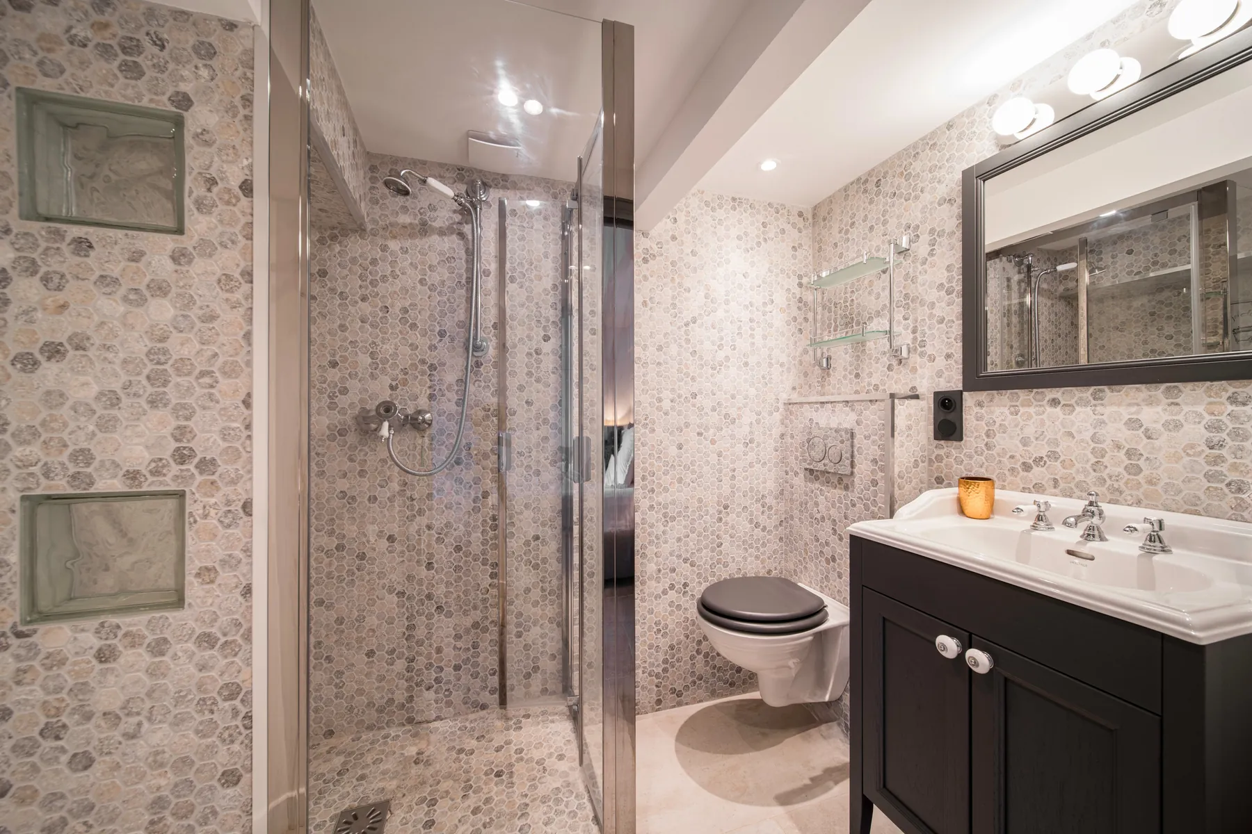 Private stone tiled bathroom with walk in shower