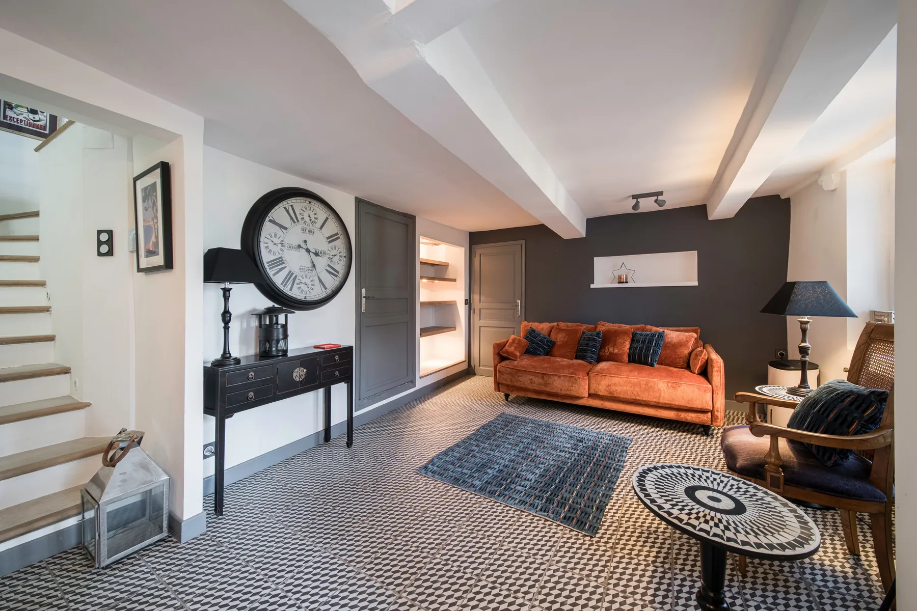 Intimate entrance lounge with an orange sofa and stone details