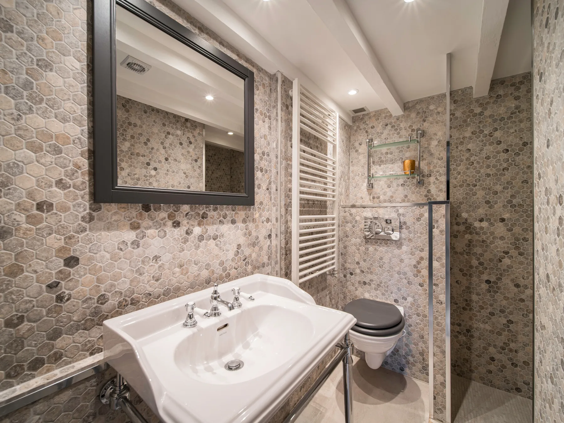 Compact en suite bathroom with stone tiles