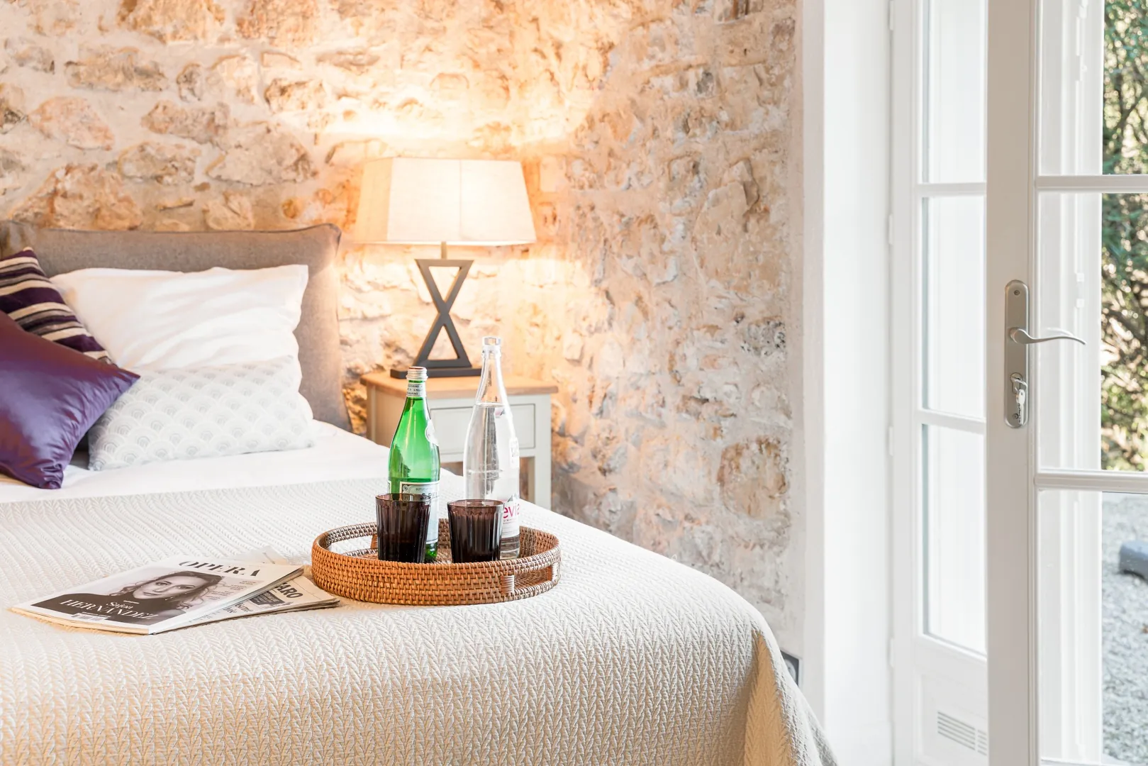 Bedside table and textured stone wall in Bedroom 3