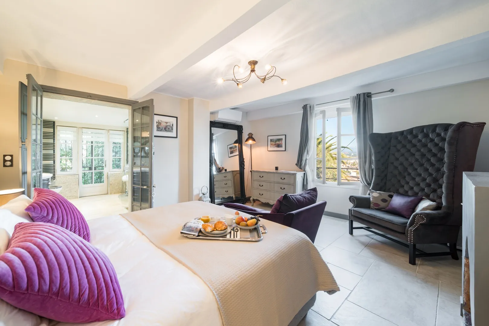 Bedroom 1 with breakfast tray, seating and adjoining bathroom